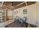 Relaxing back porch with ceiling fan, outdoor seating and wood paneling, creating a comfortable outdoor retreat at 6301 King Lawrence Rd, Raleigh, NC 27607