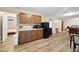 Finished basement features wood-look floors, kitchenette, cabinets, and a separate bedroom at 6301 King Lawrence Rd, Raleigh, NC 27607