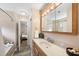 Cozy bathroom with tile shower, wood-look floors, and a vanity with ample counter space at 6301 King Lawrence Rd, Raleigh, NC 27607