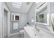Bright bathroom with skylight, vanity, and modern fixtures at 6301 King Lawrence Rd, Raleigh, NC 27607