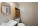 Powder room features an octagonal mirror, modern toilet, and cabinet for towels and toiletries at 6301 King Lawrence Rd, Raleigh, NC 27607