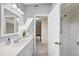 Bright bathroom features a white vanity, framed mirror, and a shower with a clear glass door at 6301 King Lawrence Rd, Raleigh, NC 27607