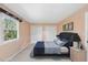 Stylish bedroom featuring a plush bed, double closets, and a bright window with decorative accents at 6301 King Lawrence Rd, Raleigh, NC 27607