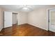 Bedroom with wood flooring, neutral walls, and natural light from a sliding door at 6301 King Lawrence Rd, Raleigh, NC 27607