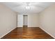 Bedroom featuring wood flooring, neutral walls, and an open doorway at 6301 King Lawrence Rd, Raleigh, NC 27607