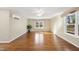 Inviting bedroom with hardwood floors, a ceiling fan, and bright windows allowing for plenty of natural light at 6301 King Lawrence Rd, Raleigh, NC 27607