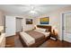 Bedroom featuring a ceiling fan, wood flooring, and neutral paint colors at 6301 King Lawrence Rd, Raleigh, NC 27607