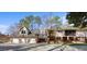 A tan home featuring a three car garage, second floor balcony and a brick foundation at 6301 King Lawrence Rd, Raleigh, NC 27607