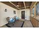 Inviting front porch with seating, ceiling fan, and view of the entry door at 6301 King Lawrence Rd, Raleigh, NC 27607