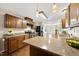 Open kitchen featuring granite countertops, wood cabinets, and stainless steel appliances at 6301 King Lawrence Rd, Raleigh, NC 27607