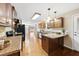Open kitchen layout with wood cabinets, granite countertops, and an adjacent dining area at 6301 King Lawrence Rd, Raleigh, NC 27607