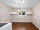 Bright laundry room with hardwood floors, storage cabinets, and a window for natural light at 6301 King Lawrence Rd, Raleigh, NC 27607