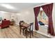 Basement living area featuring a dining table, accent window, and wood-look flooring at 6301 King Lawrence Rd, Raleigh, NC 27607