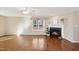 Spacious living area with hardwood flooring, a bright window, and a classic fireplace at 6301 King Lawrence Rd, Raleigh, NC 27607