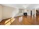 Bright living room with a charming fireplace, hardwood floors, and a view into the open-concept kitchen at 6301 King Lawrence Rd, Raleigh, NC 27607