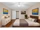 Bedroom showcasing a ceiling fan, wood flooring, and neutral paint colors at 6301 King Lawrence Rd, Raleigh, NC 27607