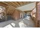 Relax on this brick patio featuring exposed wood beams and a convenient staircase at 6301 King Lawrence Rd, Raleigh, NC 27607