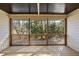 Spacious screened porch with wood flooring and a view of the surrounding nature at 6301 King Lawrence Rd, Raleigh, NC 27607