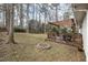 Backyard has a wooden deck, fire pit, and shade from the tree canopy at 6913 Baywood Dr, Raleigh, NC 27613