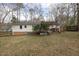Wide backyard with a wooden deck, firepit, and fenced-in parameter at 6913 Baywood Dr, Raleigh, NC 27613