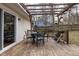 Backyard features a wooden deck with an outdoor table set, covered with a pergola at 6913 Baywood Dr, Raleigh, NC 27613