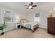 Bright bedroom with natural light from two windows, a ceiling fan, and carpet flooring at 6913 Baywood Dr, Raleigh, NC 27613