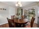 Well-lit dining area boasts a round wood table and access to the outdoor deck through sliding glass doors at 6913 Baywood Dr, Raleigh, NC 27613