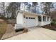View of attached garage, front porch, and driveway with stone pathway and planter near the home at 6913 Baywood Dr, Raleigh, NC 27613