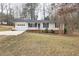 Charming one-story home featuring a manicured lawn, welcoming front porch, and attached garage at 6913 Baywood Dr, Raleigh, NC 27613