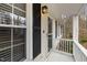 View of the front porch with white railings, black door accents, and exterior lighting at 6913 Baywood Dr, Raleigh, NC 27613