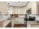 Charming kitchen with granite countertops, modern appliances, and convenient cabinet storage at 6913 Baywood Dr, Raleigh, NC 27613