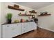 Office area featuring hardwood floors, built in cabinets, and floating shelves above work area at 6913 Baywood Dr, Raleigh, NC 27613