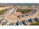 This aerial view showcases a suburban neighborhood with neatly arranged homes, streets, and a greenbelt on a clear day at 710 Legacy Falls S S Dr, Chapel Hill, NC 27517