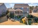 Expansive backyard featuring a patio, play set, and lush greenery, offering plenty of space for outdoor activities at 710 Legacy Falls S S Dr, Chapel Hill, NC 27517