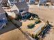 An aerial view of a backyard featuring a well-maintained lawn, patio with a fire pit, and playground equipment at 710 Legacy Falls S S Dr, Chapel Hill, NC 27517