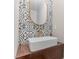 Modern powder room featuring stylish tile backsplash, floating wood countertop, and vessel sink at 710 Legacy Falls S S Dr, Chapel Hill, NC 27517