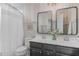 Charming bathroom with double vanity, decorative mirrors, and patterned wallpaper, exuding a cozy ambiance at 710 Legacy Falls S S Dr, Chapel Hill, NC 27517