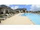 Resort-style pool area with sun loungers and a covered outdoor seating area with a fireplace at 710 Legacy Falls S S Dr, Chapel Hill, NC 27517