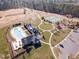 Aerial view of a community pool, tennis courts, and a clubhouse surrounded by mature trees and manicured lawns at 710 Legacy Falls S S Dr, Chapel Hill, NC 27517