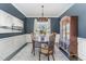 Elegant dining room features dark walls, wainscoting, modern chandelier, and built-in china cabinet at 710 Legacy Falls S S Dr, Chapel Hill, NC 27517