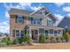 Beautiful home with a mix of stone and siding, enhanced by professional landscaping at 710 Legacy Falls S S Dr, Chapel Hill, NC 27517