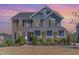 Charming two-story home with stone and siding, complemented by lush landscaping at 710 Legacy Falls S S Dr, Chapel Hill, NC 27517