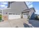Three car garage with stone accents, carriage doors and ample parking on a paved driveway at 710 Legacy Falls S S Dr, Chapel Hill, NC 27517