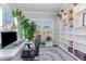 Bright home office features a built-in bookcase, large windows, and an area rug at 710 Legacy Falls S S Dr, Chapel Hill, NC 27517