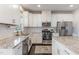 Well-lit kitchen boasting granite countertops, stainless steel appliances, and ample cabinet space at 710 Legacy Falls S S Dr, Chapel Hill, NC 27517