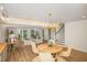 Open living area boasts a dining table, seating area, and staircase with hardwood floors and lots of natural light at 710 Legacy Falls S S Dr, Chapel Hill, NC 27517