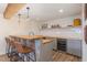 Attractive wet bar with custom tiling, counter seating, and a beverage refrigerator at 710 Legacy Falls S S Dr, Chapel Hill, NC 27517