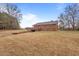 Spacious backyard with a wooden deck and convenient basement garage access at 7415 Old Oxford Rd, Bahama, NC 27503