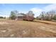Home exterior showcasing a wooden deck and large yard at 7415 Old Oxford Rd, Bahama, NC 27503