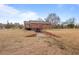 Exterior view featuring a wooden deck and convenient basement garage access at 7415 Old Oxford Rd, Bahama, NC 27503